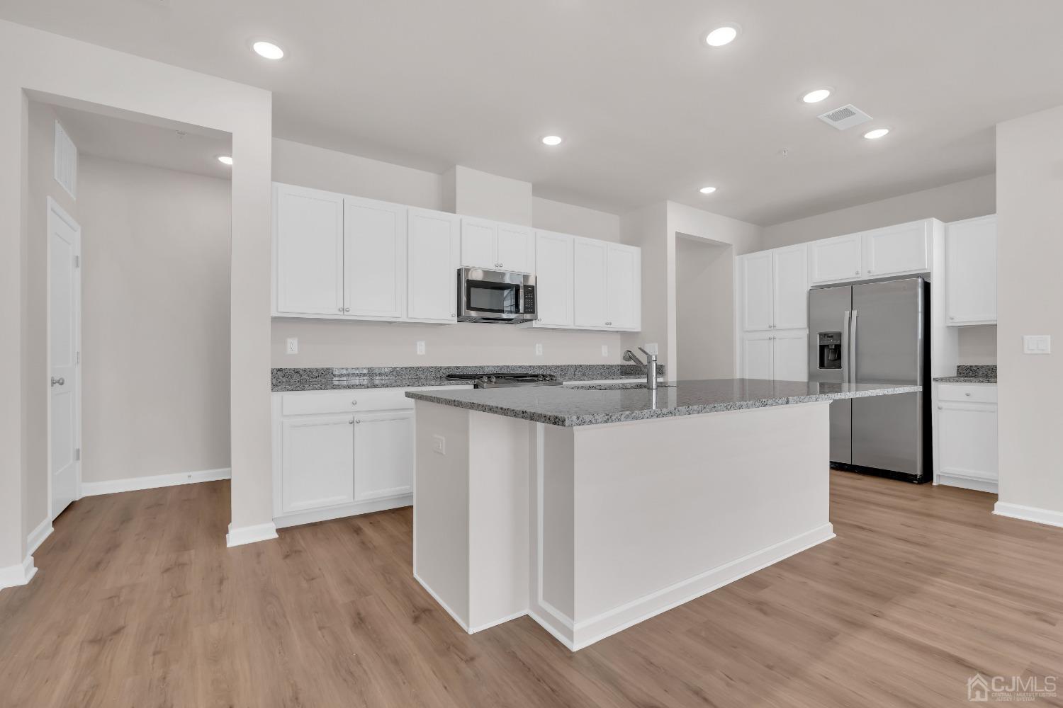 75 Depot Way Dunellen, NJ 08812 - Photo 8 of 28 a kitchen with stainless steel appliances granite countertop a stove a sink and a refrigerator