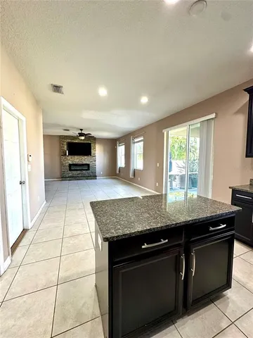 a kitchen with granite countertop a sink and a stove