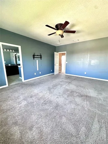 a view of a big room with closet and a ceiling fan