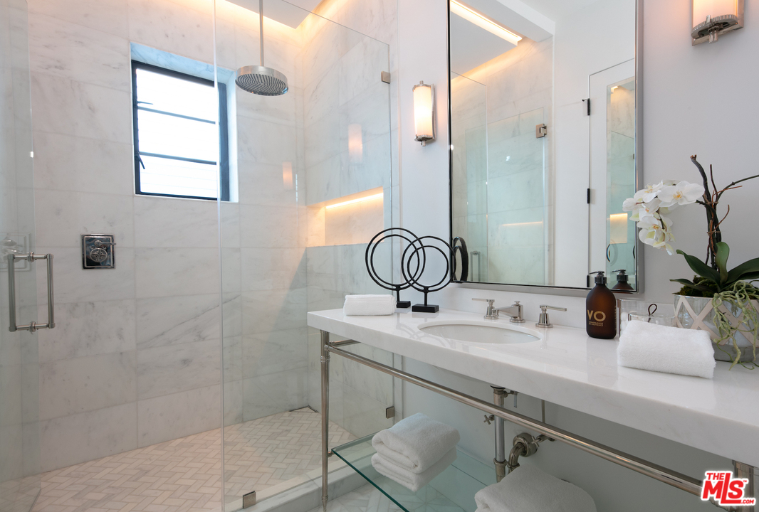 130 Roma Court Marina del Rey, CA 90292 - Photo 13 of 27 a bathroom with a sink a mirror and shower