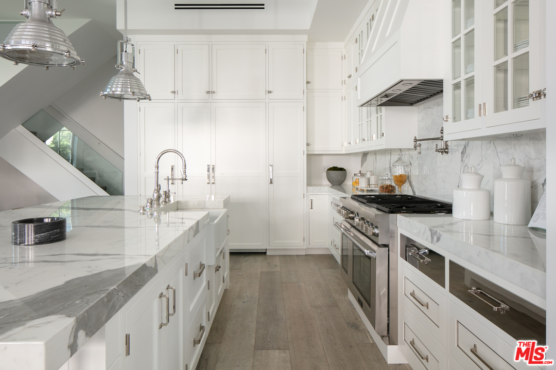 130 Roma Court Marina del Rey, CA 90292 - Photo 3 of 27 a kitchen with kitchen island a sink stove and cabinets