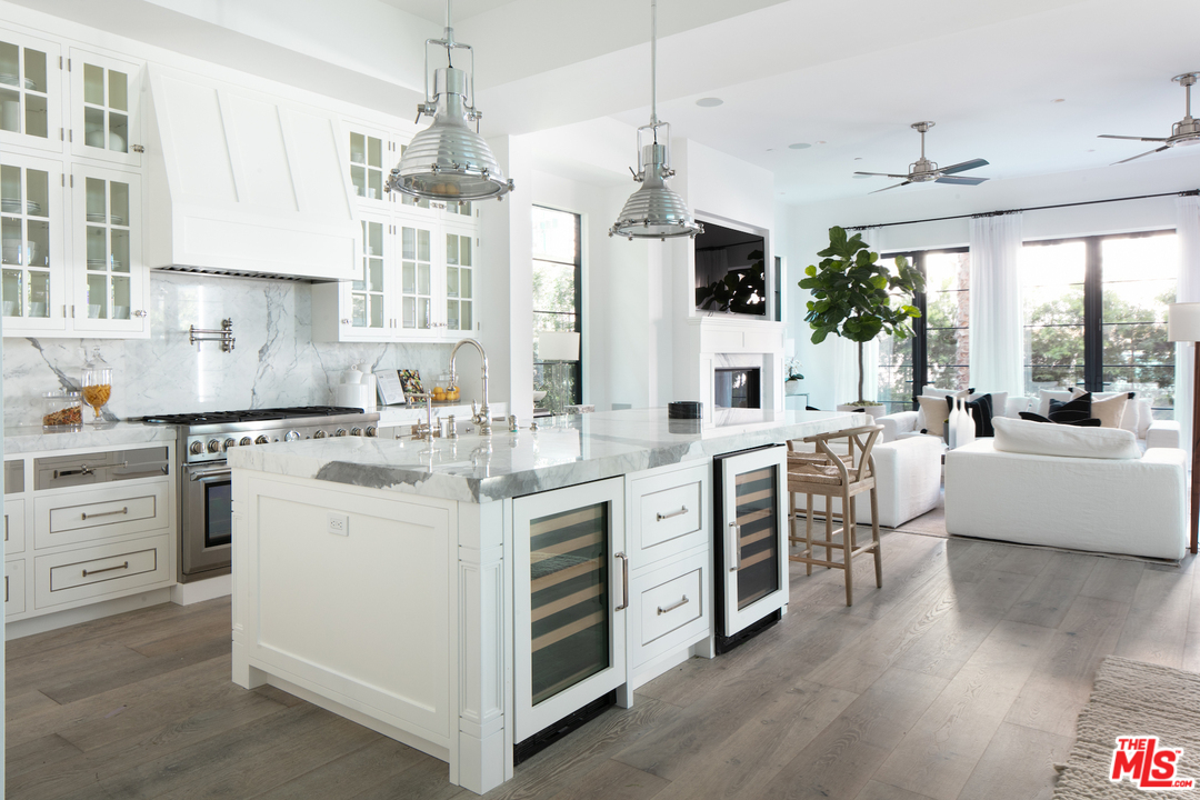130 Roma Court Marina del Rey, CA 90292 - Photo 4 of 27 a kitchen with white cabinets and white appliances