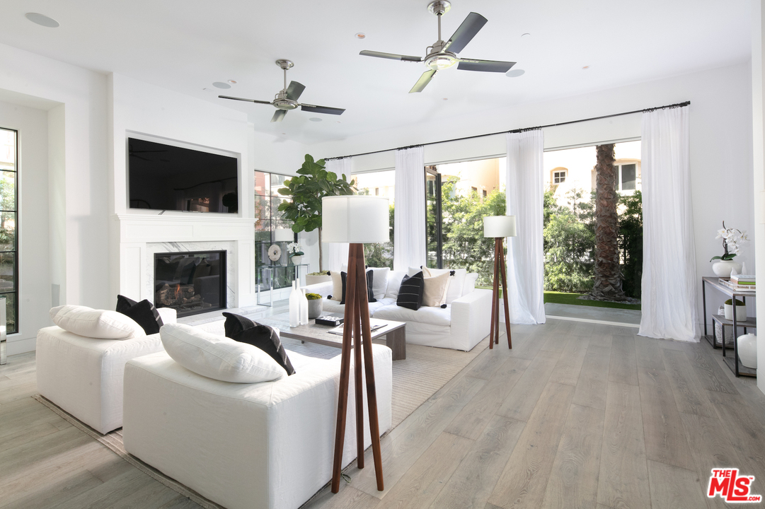 130 Roma Court Marina del Rey, CA 90292 - Photo 6 of 27 a living room with furniture a flat screen tv and a fireplace