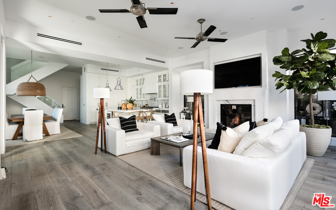 130 Roma Court Marina del Rey, CA 90292 - Photo 8 of 27 a living room with furniture a fireplace and a flat screen tv