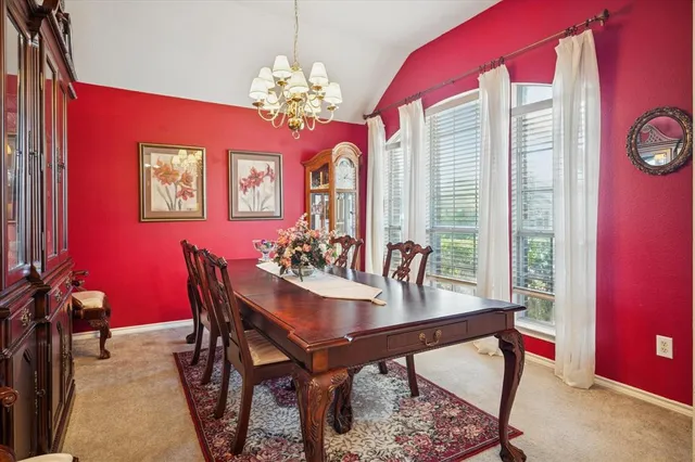 a view of a dining room with furniture and a chandelier