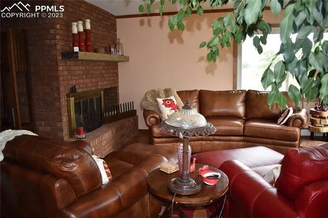 a living room with furniture and a fireplace
