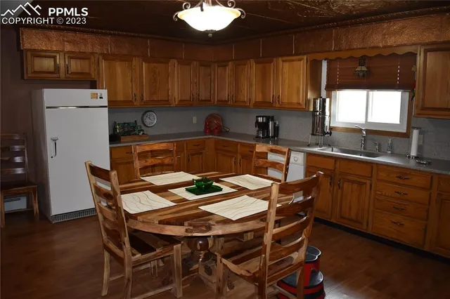 a kitchen with a table chairs sink and cabinets