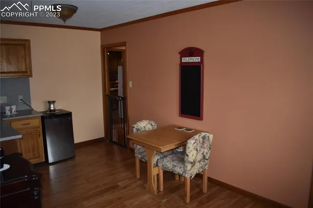 a view of a workspace with furniture and wooden floor