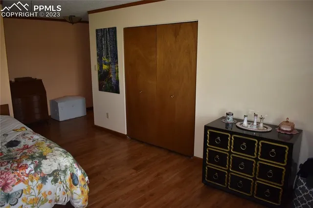 a bedroom with a bed and a chair