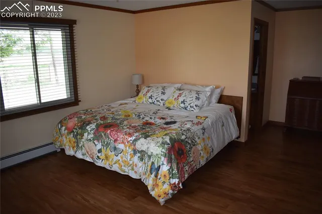 a large bed sitting in a bedroom next to a window