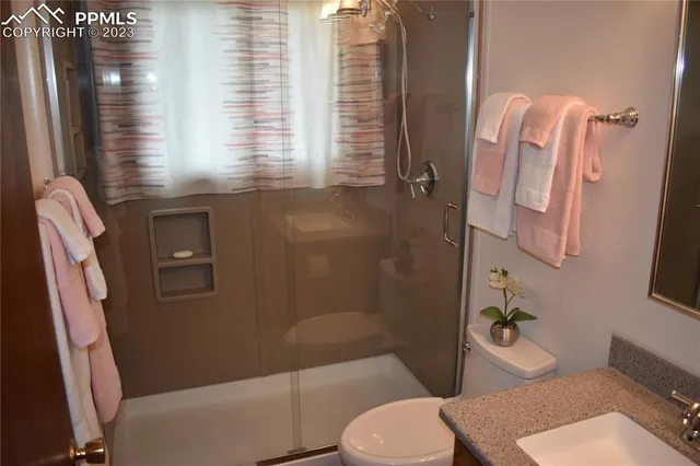 a bathroom with a toilet and a shower