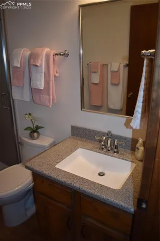 a bathroom with a sink toilet and mirror