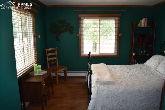 a bed sitting in a bedroom next to a window