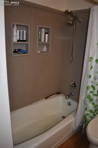 a bathroom with a tub and shower