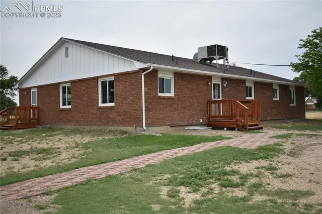 a front view of a house with yard and trees