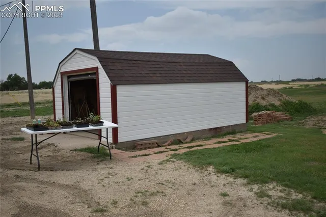 a view of two chairs in the backyard