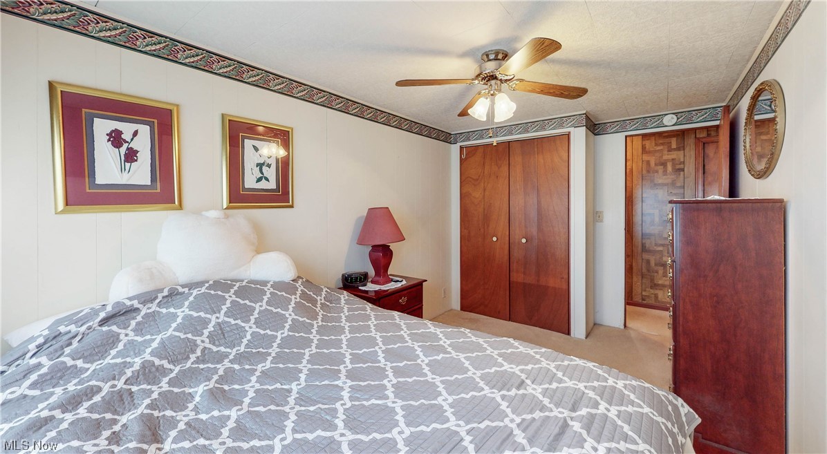 466 Pine Lake Road Sebring, OH 44672 - Photo 23 of 30 Carpeted bedroom featuring a closet, a textured ceiling, and ceiling fan
