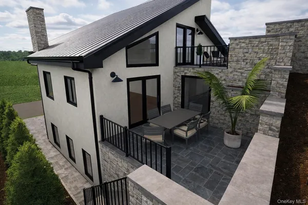 a front view of a house with barbeque grill and seating area