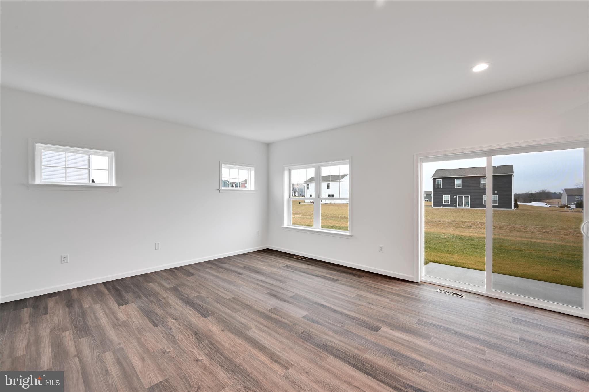10659 Jonestown Road Annville, PA 17003 - Photo 8 of 32 an empty room with wooden floor and windows