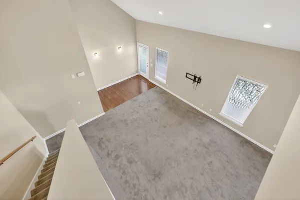 a view of a balcony with wooden floor and fence