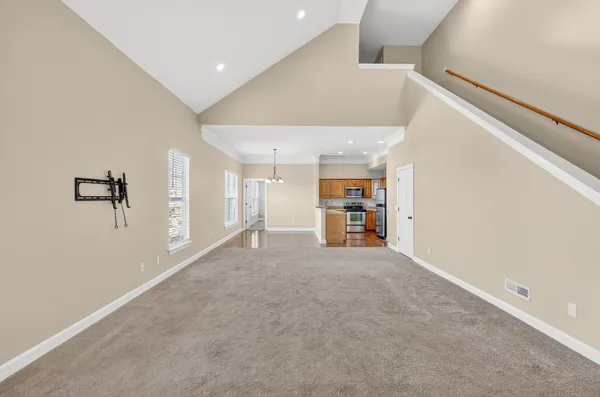 a kitchen with stainless steel appliances granite countertop a sink stove microwave and refrigerator