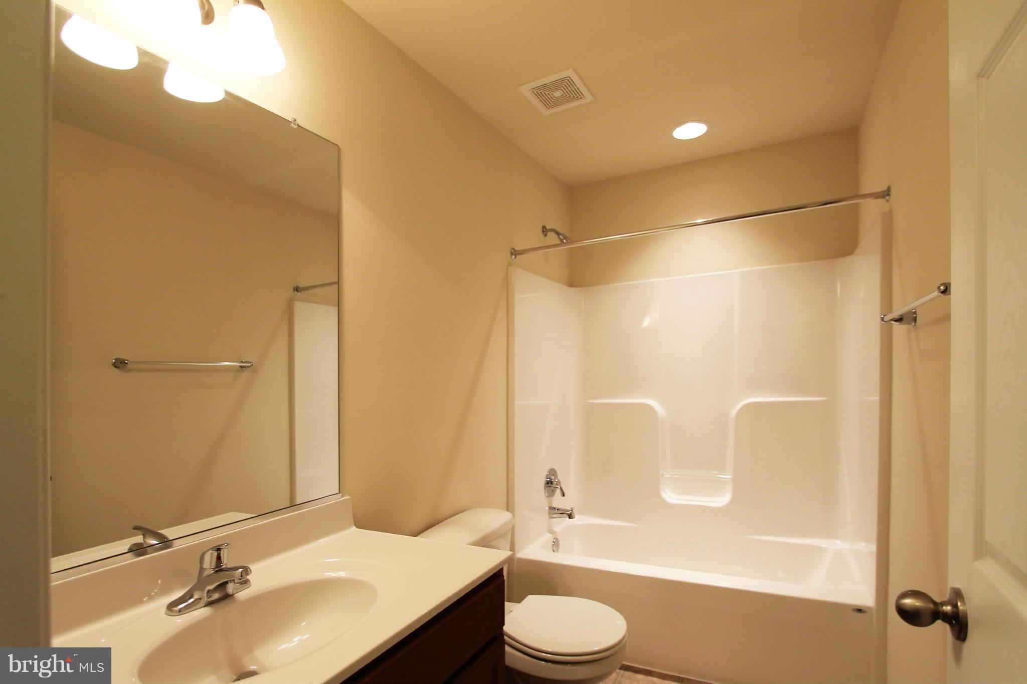 1136 Stallion Street Ranson, WV 25438 - Photo 17 of 23 a bathroom with a sink a toilet and shower