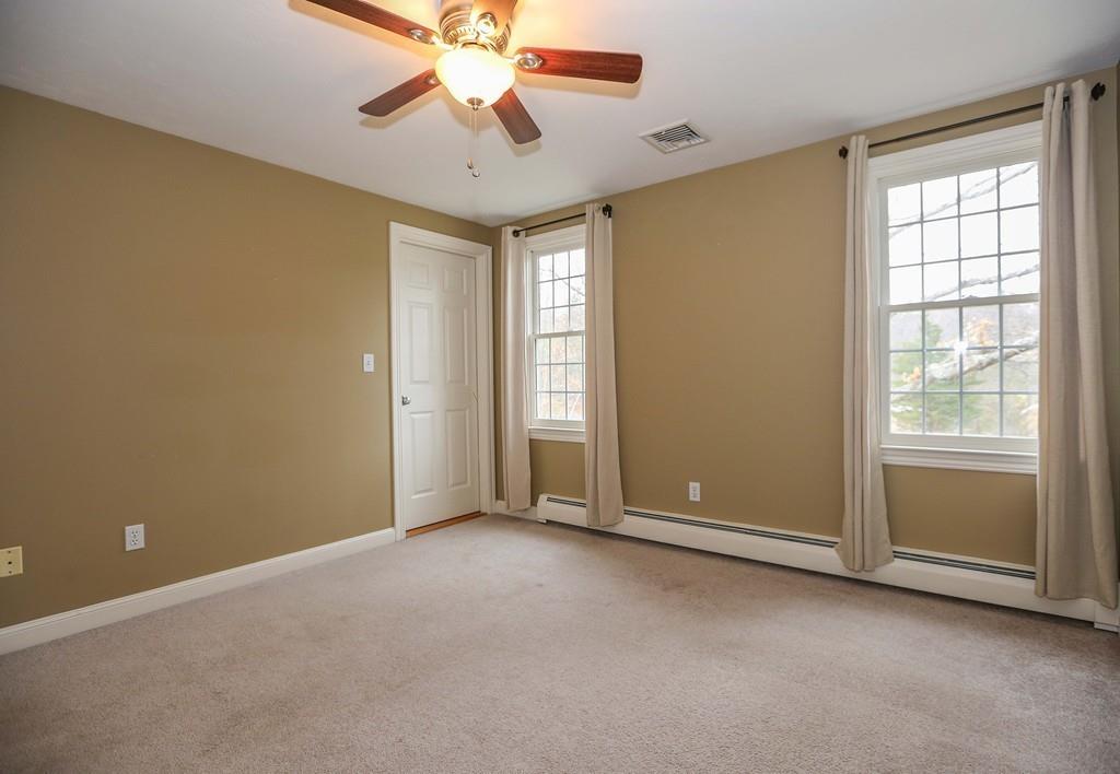 323 Sugar Road Bolton, MA 01740 - Photo 18 of 35 an empty room with windows and fan
