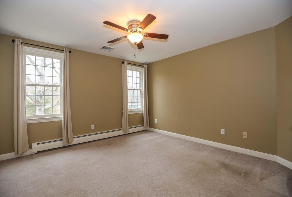 323 Sugar Road Bolton, MA 01740 - Photo 21 of 35 an empty room with windows and fan