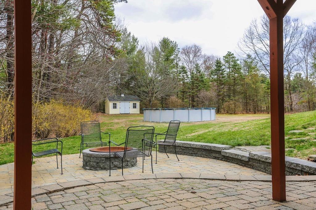 323 Sugar Road Bolton, MA 01740 - Photo 30 of 35 a view of a chairs and table in the patio