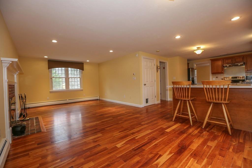 323 Sugar Road Bolton, MA 01740 - Photo 5 of 35 a view of a room with wooden floor and windows
