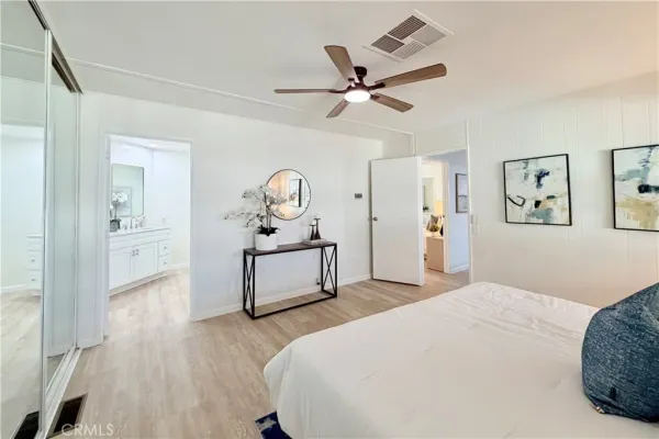 a spacious bathroom with a tub sink and mirror