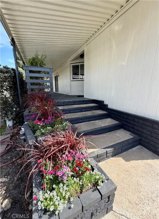 a view of a patio with dining table and chairs with a yard