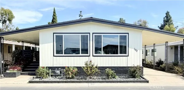 a front view of a house with sitting area