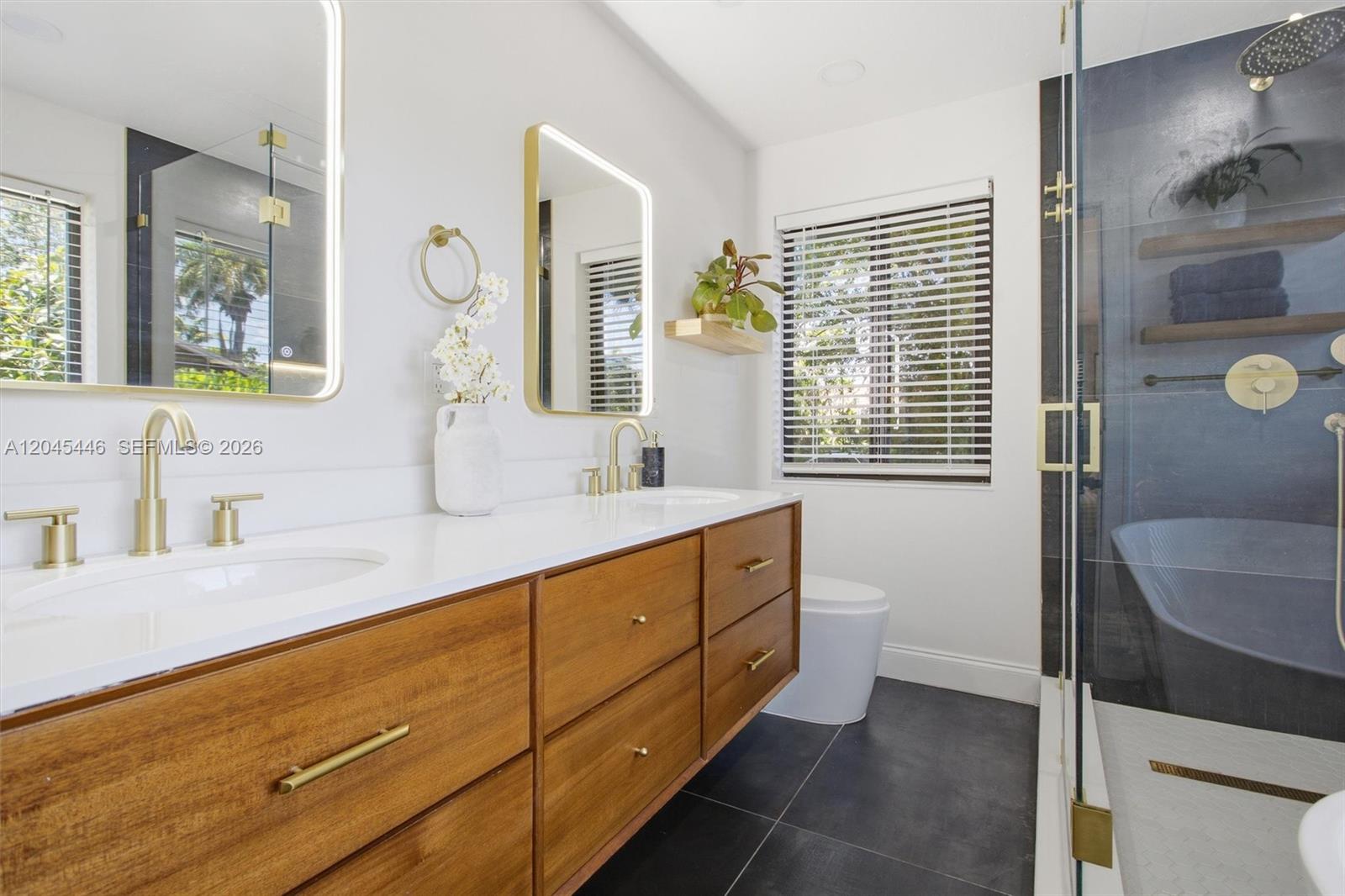 8440 Southwest 180th Street Palmetto Bay, FL 33157 - Photo 26 of 54 a bathroom with a sink double vanity and a mirror