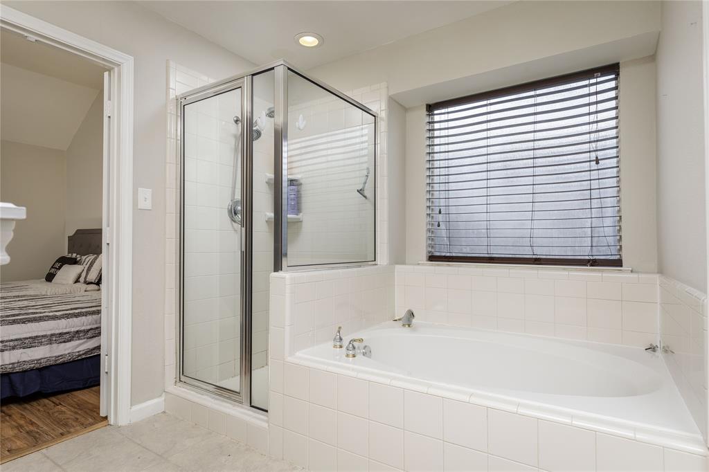 4108 Fryer Street The Colony, TX 75056 - Photo 18 of 27 a bathroom with a bathtub and a shower