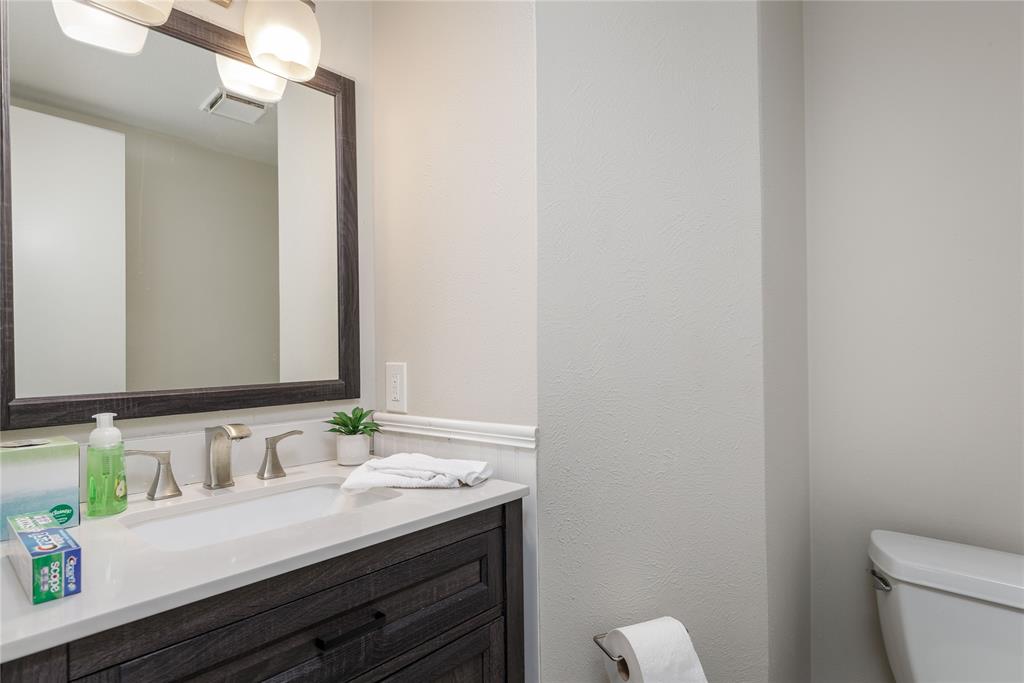 4108 Fryer Street The Colony, TX 75056 - Photo 19 of 27 a bathroom with a granite countertop sink and a mirror
