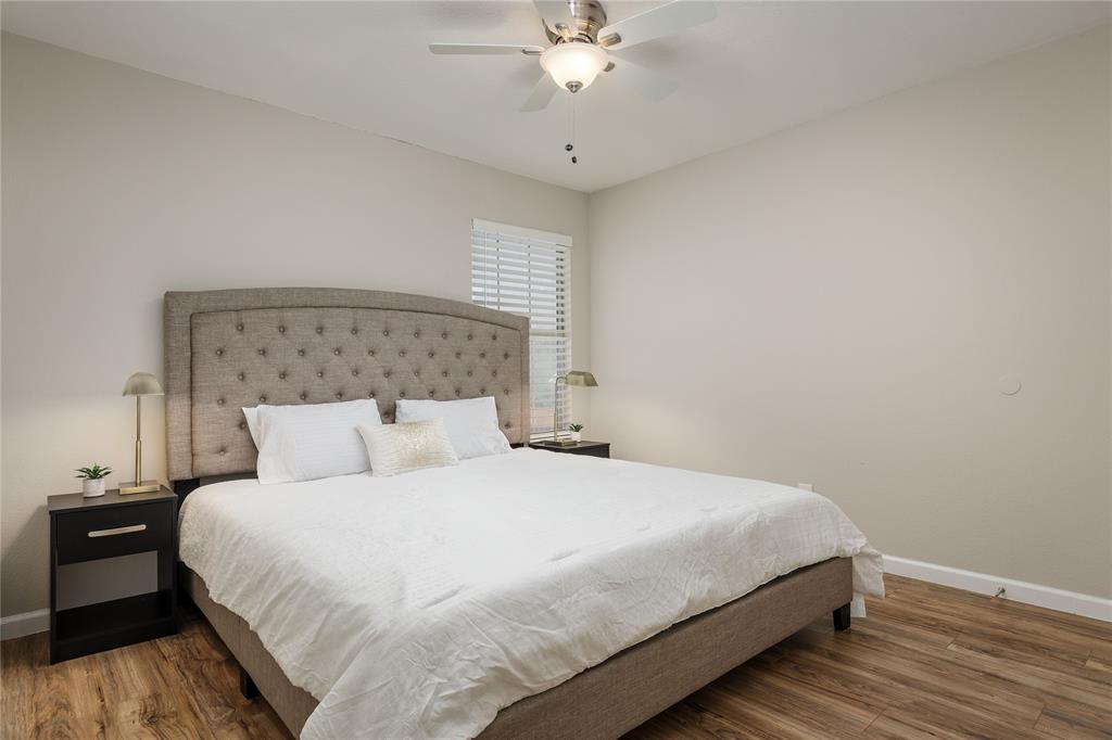 4108 Fryer Street The Colony, TX 75056 - Photo 21 of 27 a bedroom with a bed and a chandelier