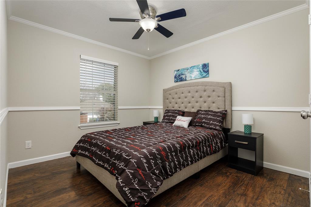 4108 Fryer Street The Colony, TX 75056 - Photo 22 of 27 a bedroom with a bed and a chandelier