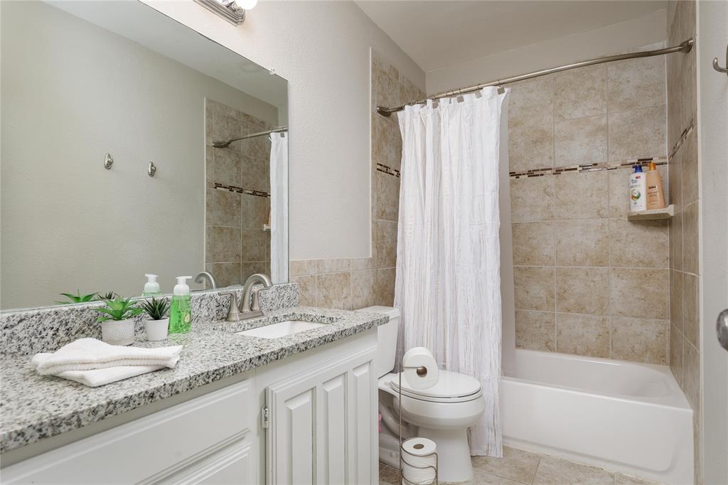 4108 Fryer Street The Colony, TX 75056 - Photo 23 of 27 a bathroom with a granite countertop sink toilet and shower