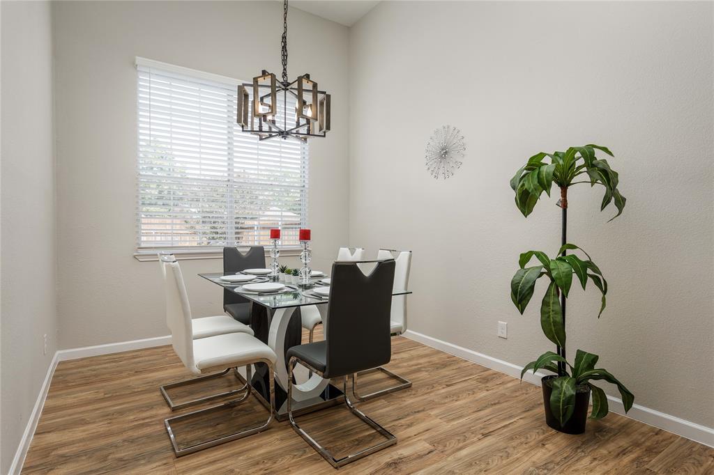 4108 Fryer Street The Colony, TX 75056 - Photo 10 of 27 a dining room with furniture potted plants and wooden floor