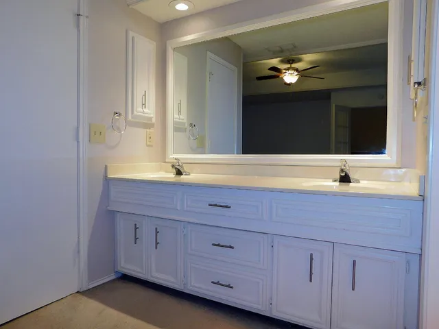 a bathroom with a sink vanity and mirror