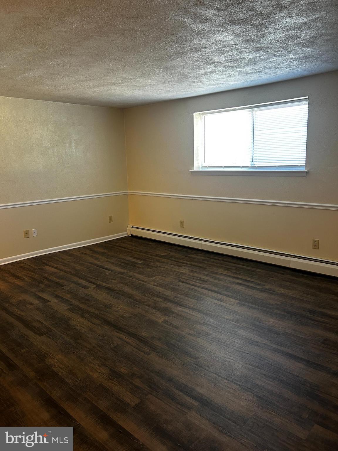 120 North Penn Street, Unit C3 Spring City, PA 19475 - Photo 3 of 8 an empty room with wooden floor and windows