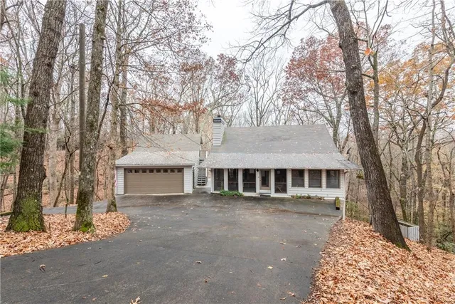 a view of a large white house with a large tree