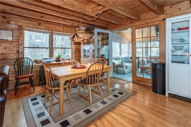 a view of a dining room with furniture large windows and wooden floor