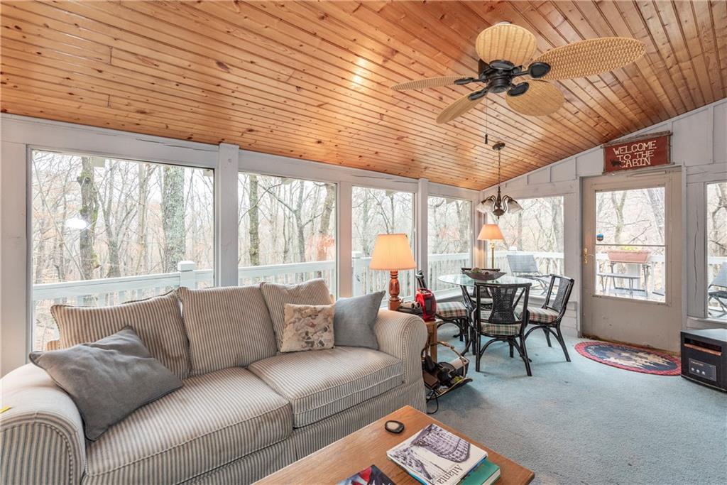 78 Ripple Creek Court Jasper, GA 30143 - Photo 12 of 43 a living room with furniture a ceiling fan and a large window