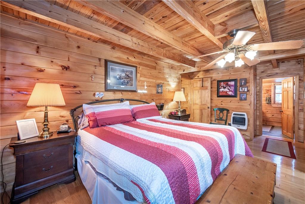 78 Ripple Creek Court Jasper, GA 30143 - Photo 16 of 43 a bedroom with a bed and wooden cabinets