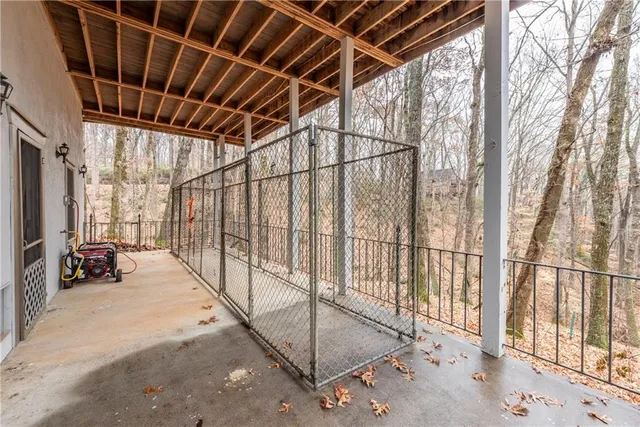 a view of a deck with chairs and wooden fence