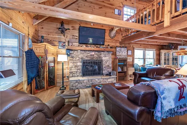 a living room with furniture a fireplace and a flat screen tv
