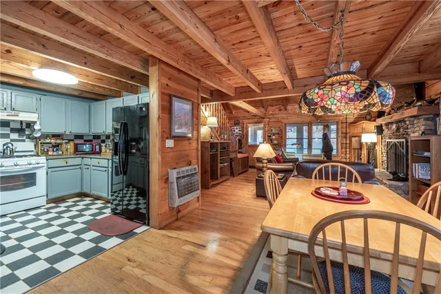 a view of a kitchen with dining table and chairs