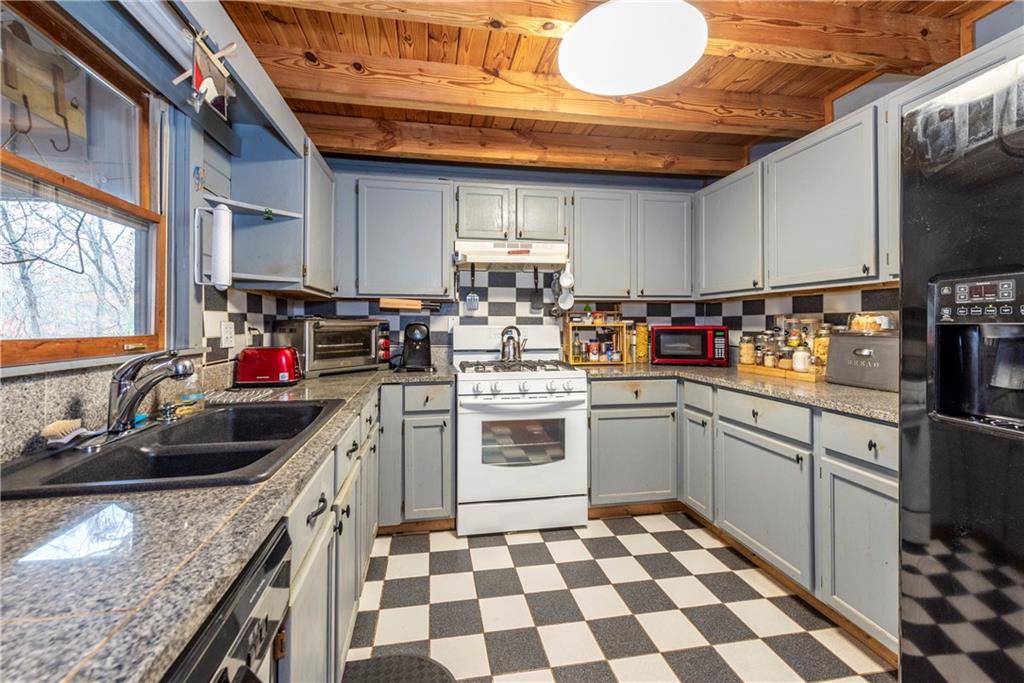 78 Ripple Creek Court Jasper, GA 30143 - Photo 10 of 43 a kitchen with stainless steel appliances granite countertop a sink stove and cabinets
